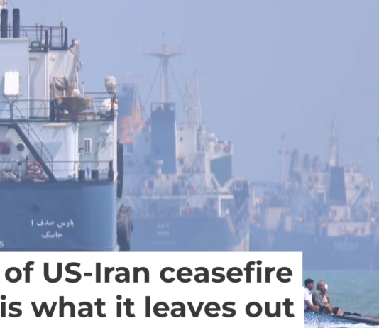 A small motorboat passes anchored vessels in the Strait of Hormuz off Bandar Abbas, Iran, on June 11, 2026. Amirhosein Khorgooi/ISNA via AP